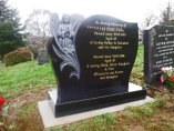 WB6 - All Polished Black Headstone with Deep Carved Flower and Angel.